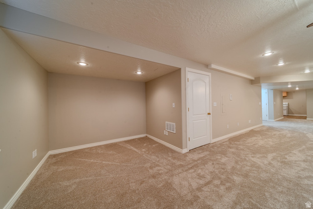 598 Hollow Creek Road Draper, UT 84020 - Photo 48 of 110 Expansive carpeted area with recessed lighting, neutral wall tones, white baseboards, and a white interior door