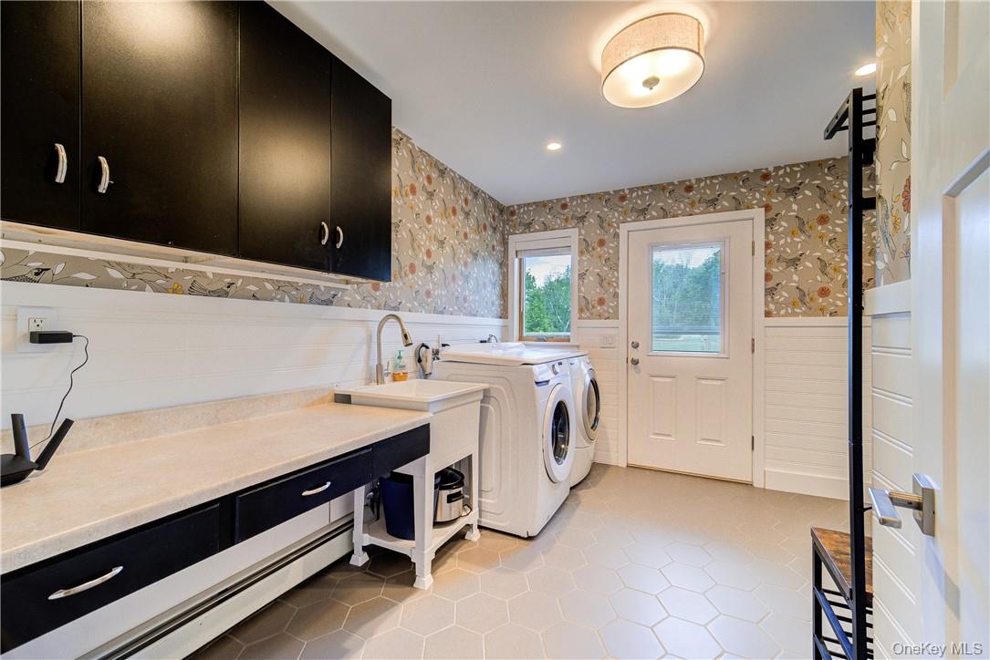 90 Onderdonk Road Warwick, NY 10990 - Photo 16 of 32 Storage cabinets, a sink and massive folding table make this mud/room - laundry center a terrific space! It also offers direct access right to the backyard!