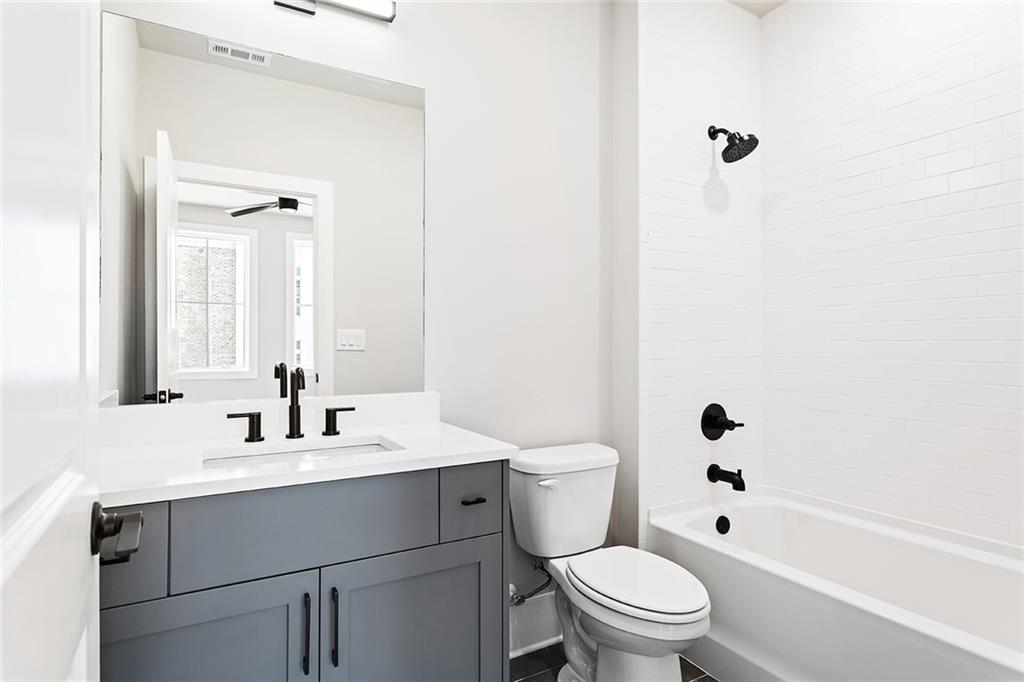 7150 Summit Place Alpharetta, GA 30009 - Photo 13 of 33 a bathroom with a sink a toilet and a mirror