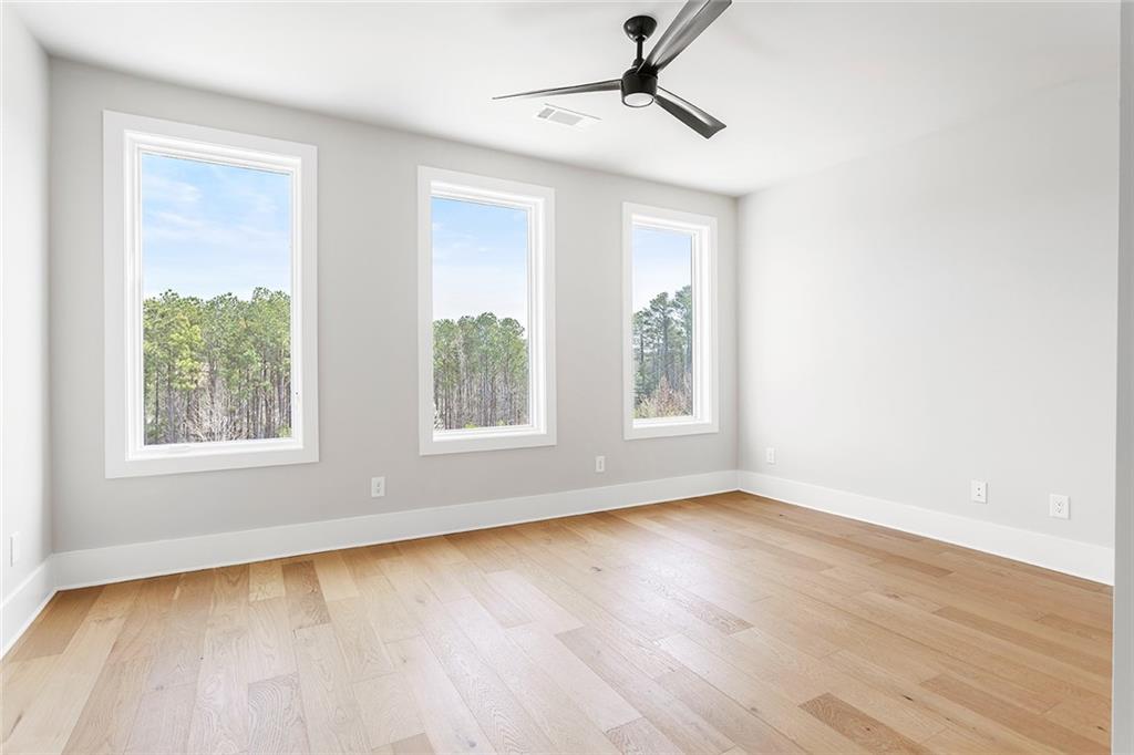 7150 Summit Place Alpharetta, GA 30009 - Photo 14 of 33 a view of empty room with wooden floor and fan