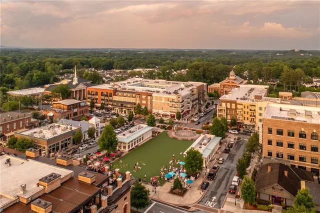 an aerial view of residential houses with city view