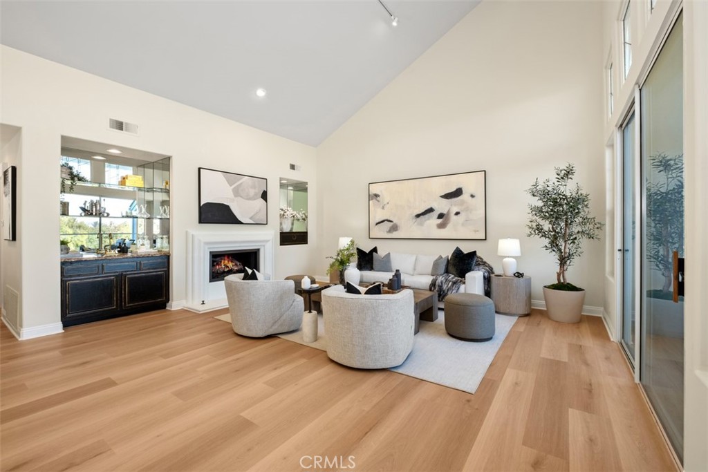 22 Delphinus Irvine, CA 92603 - Photo 13 of 42 a living room with furniture a fireplace and a large window