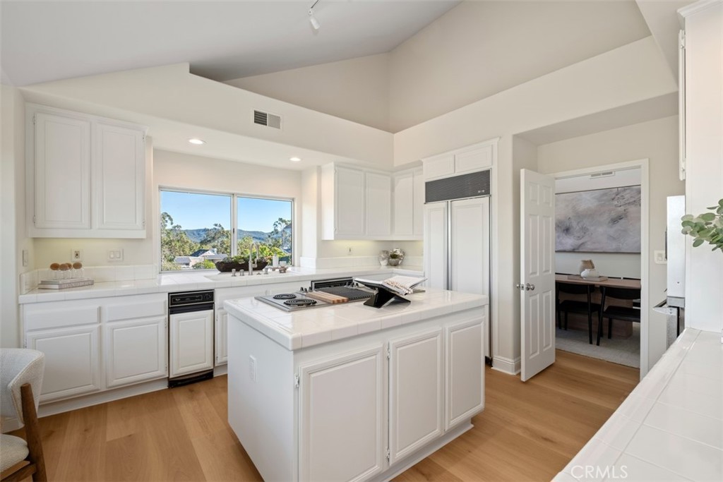 22 Delphinus Irvine, CA 92603 - Photo 23 of 42 a kitchen with white cabinets and appliances
