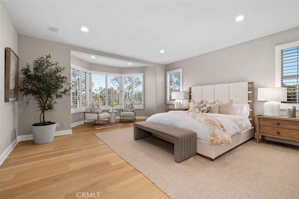 22 Delphinus Irvine, CA 92603 - Photo 33 of 42 a spacious bedroom with a large bed and a potted plant