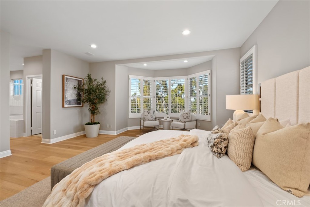 22 Delphinus Irvine, CA 92603 - Photo 34 of 42 a bedroom with a large bed and large windows