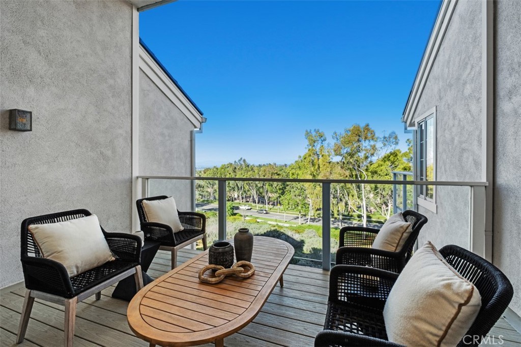 22 Delphinus Irvine, CA 92603 - Photo 9 of 42 a balcony with wooden floor table and chairs