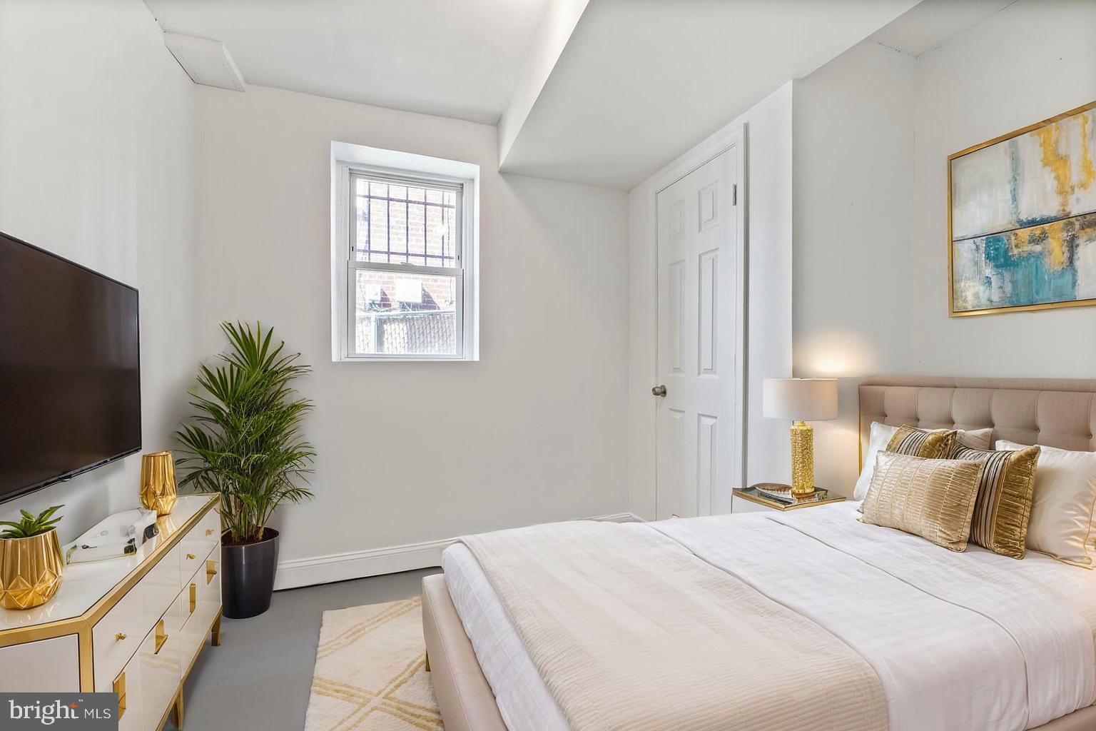 212 Division Avenue Northeast Washington, DC 20019 - Photo 13 of 21 a bedroom with a bed and a flat screen tv