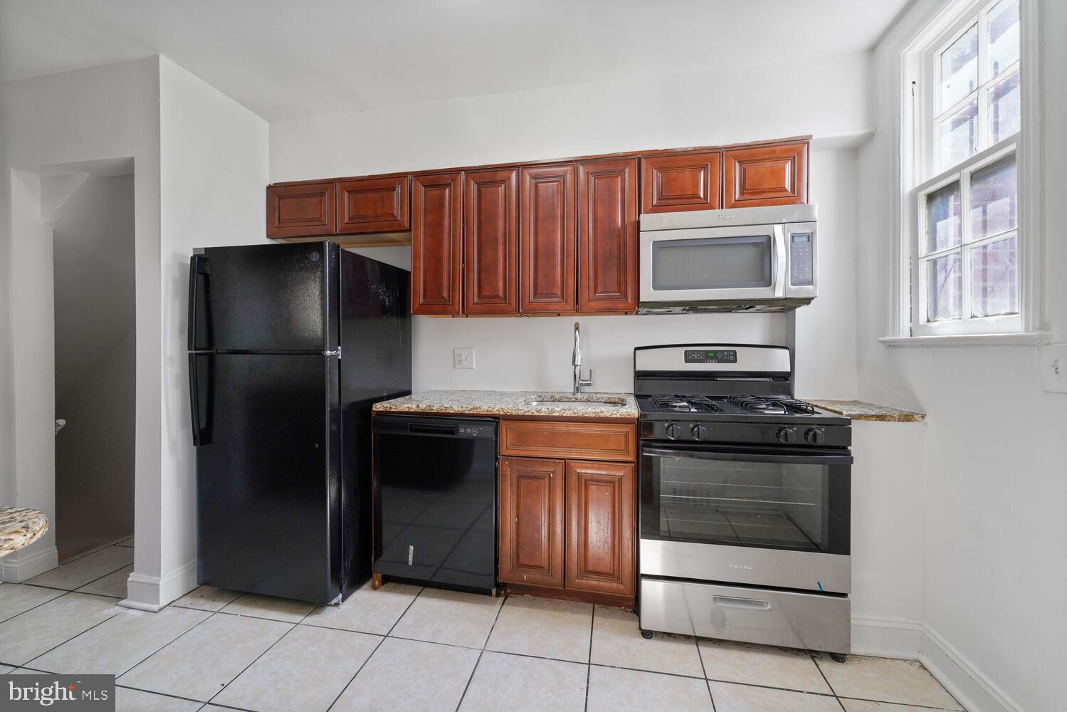 212 Division Avenue Northeast Washington, DC 20019 - Photo 4 of 21 a kitchen with stainless steel appliances granite countertop a refrigerator stove and oven