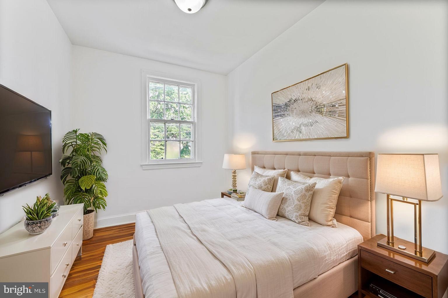 212 Division Avenue Northeast Washington, DC 20019 - Photo 9 of 21 a bedroom with bed and a painting on the wall