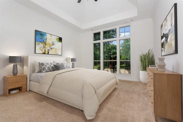 a bedroom with a large bed and a large window