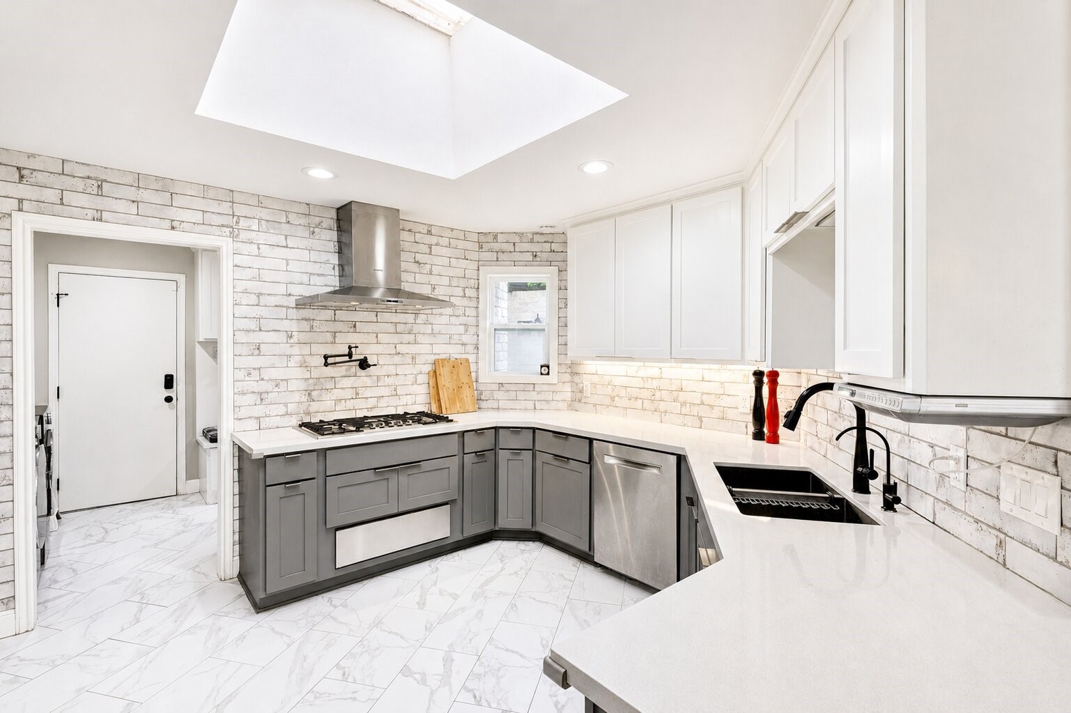 201 Vanderpool Lane, Unit 130 Houston, TX 77024 - Photo 13 of 41 The spacious kitchen features stainless steel appliances, gas range, pot filler and a subway tile backsplash that extends up to the ceiling. The cased opening to the left leads to the laundry room / mud room.