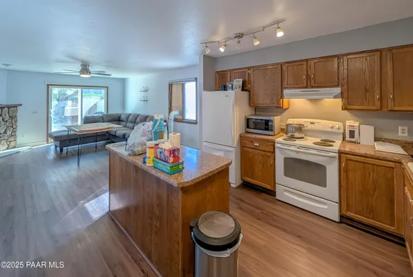 a kitchen that has a sink stainless steel appliances and cabinets
