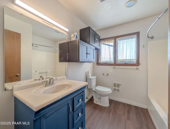 a bathroom with a sink toilet and a mirror