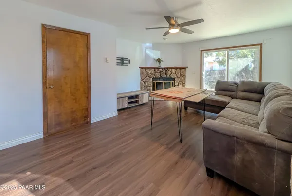 a living room with furniture and a wooden floor