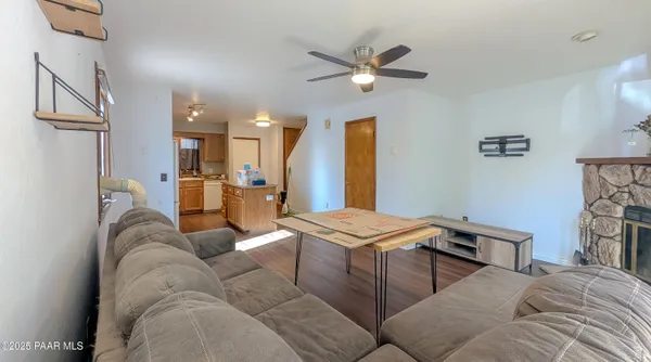 a living room with furniture and kitchen view