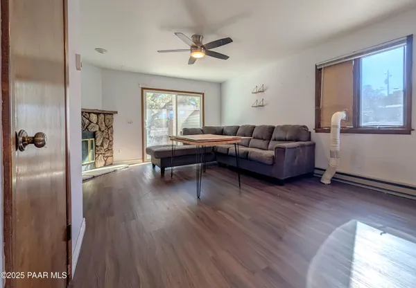 a living room with furniture and a wooden floor