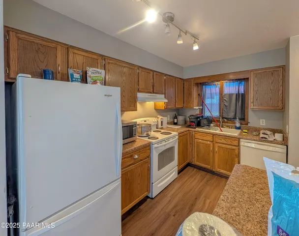 a kitchen with a sink stove and refrigerator
