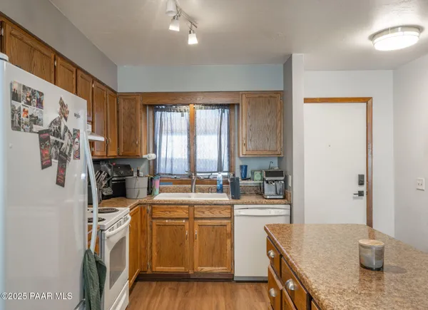 a kitchen with a sink stove and refrigerator