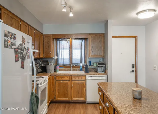 a kitchen that has a sink stainless steel appliances and cabinets
