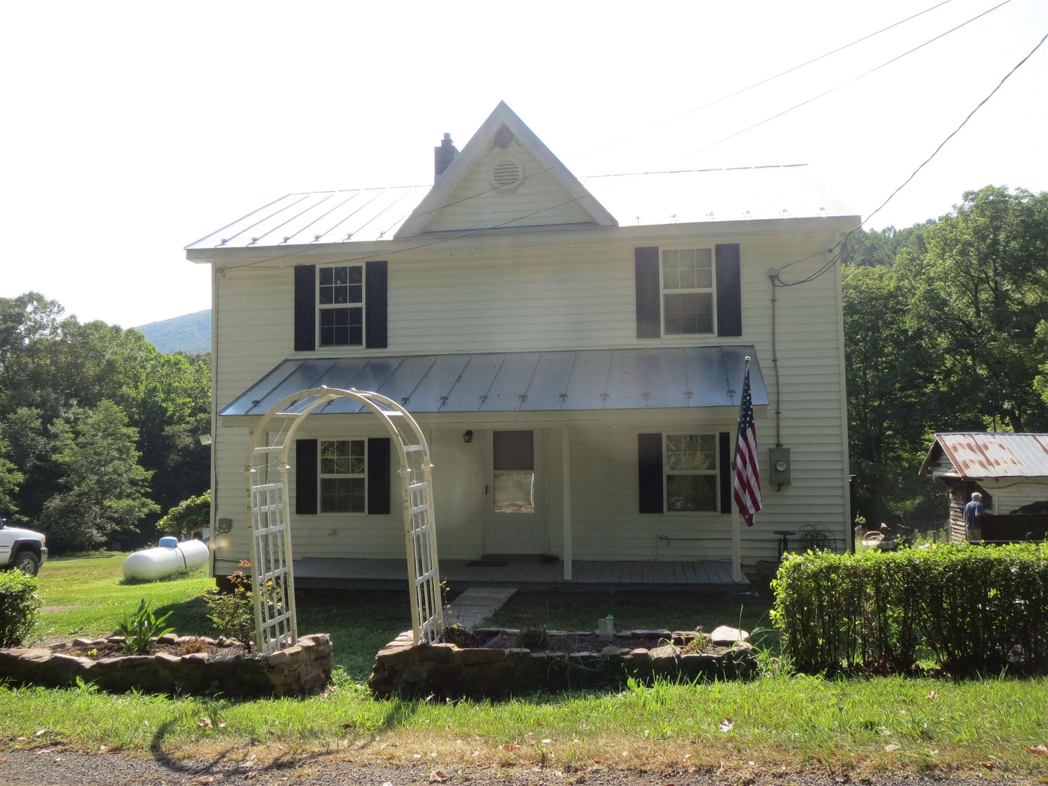 2600 Middle Cove Run Road Mathias, WV 26812 - Photo 12 of 38 a front view of a house with a yard and garage