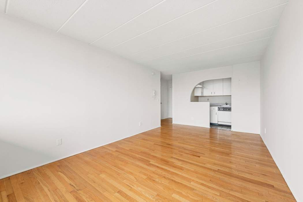 23-22 30th Road, Unit 10H Queens, NY 11102 - Photo 7 of 16 a view of empty room with wooden floor