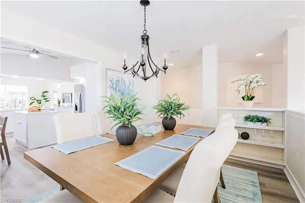 a kitchen with a sink a stove and chairs
