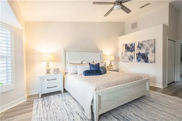 a bedroom with a large bed and a window