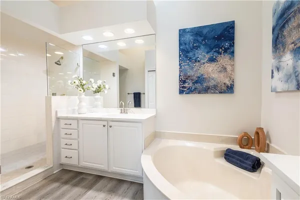 a bathroom with a granite countertop sink a toilet and shower