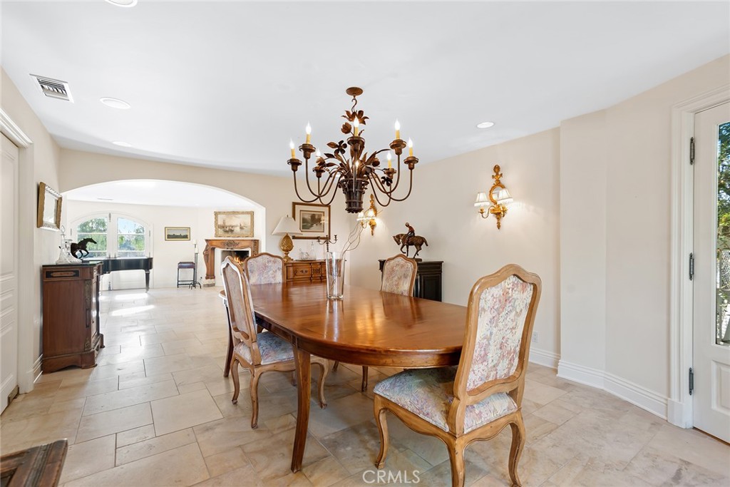 5747 Hoback Glen Road Hidden Hills, CA 91302 - Photo 13 of 37 a dining room with furniture and chandelier