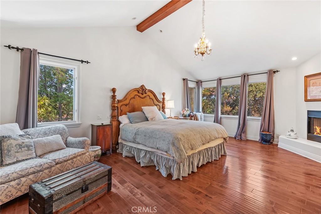 5747 Hoback Glen Road Hidden Hills, CA 91302 - Photo 18 of 37 a bedroom with a bed wooden floor and window