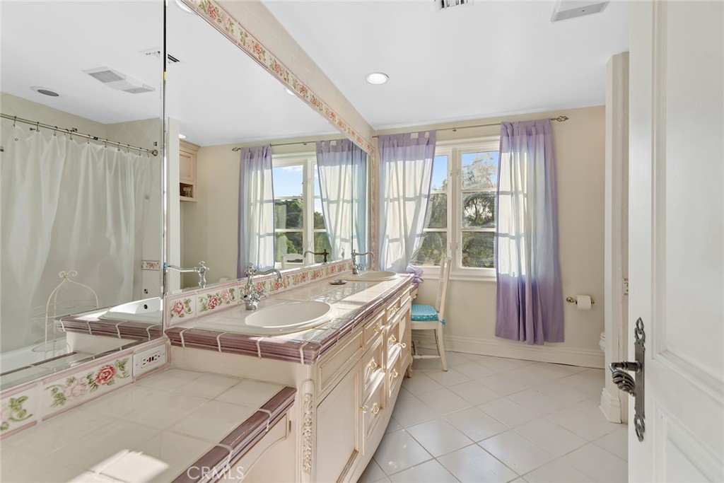 5747 Hoback Glen Road Hidden Hills, CA 91302 - Photo 20 of 37 a spacious bathroom with a tub sink and mirror