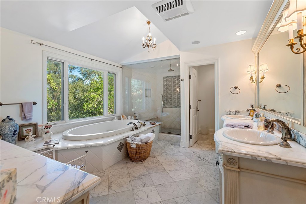 5747 Hoback Glen Road Hidden Hills, CA 91302 - Photo 21 of 37 a spacious bathroom with a tub sink and mirror
