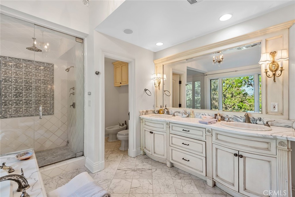 5747 Hoback Glen Road Hidden Hills, CA 91302 - Photo 23 of 37 a spacious bathroom with a double vanity sink toilet and shower