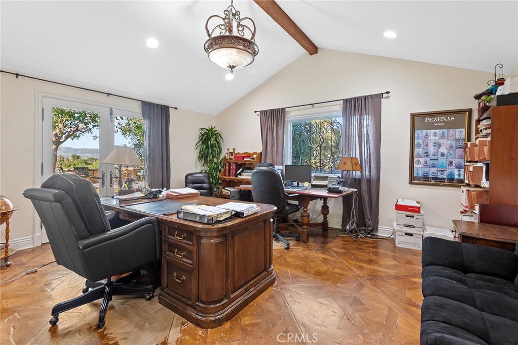 5747 Hoback Glen Road Hidden Hills, CA 91302 - Photo 24 of 37 a living room with furniture a large window and a chandelier