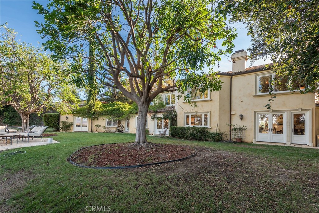 5747 Hoback Glen Road Hidden Hills, CA 91302 - Photo 27 of 37 a view of a white house next to a yard with big trees