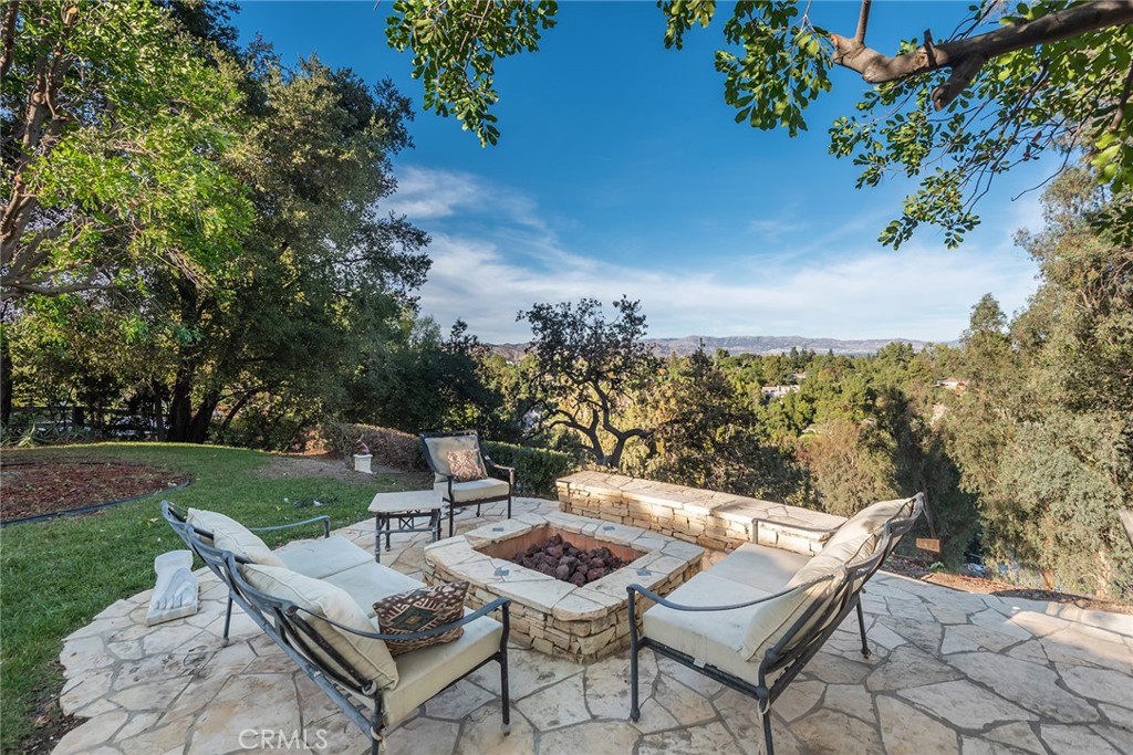 5747 Hoback Glen Road Hidden Hills, CA 91302 - Photo 29 of 37 a view of a patio with a table and chairs