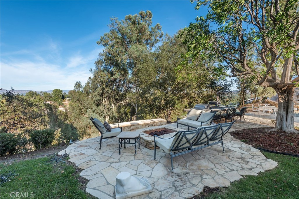 5747 Hoback Glen Road Hidden Hills, CA 91302 - Photo 30 of 37 a backyard of a house with table and chairs