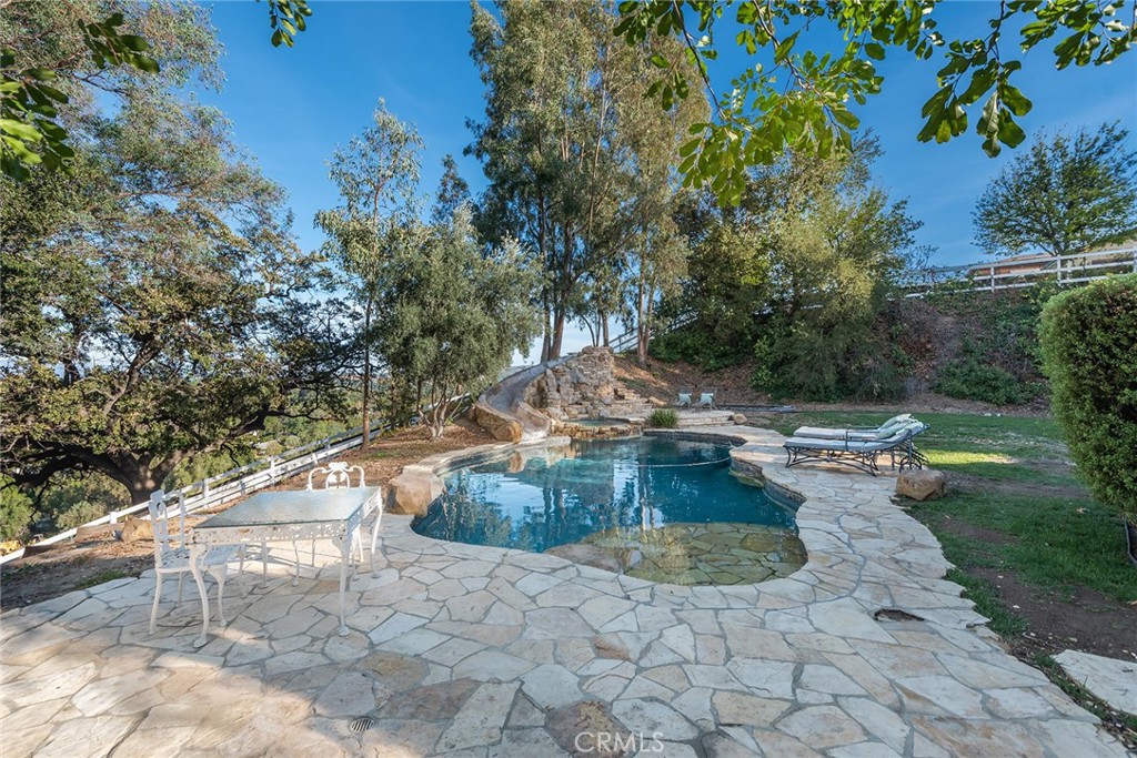 5747 Hoback Glen Road Hidden Hills, CA 91302 - Photo 32 of 37 a view of a swimming pool with a yard
