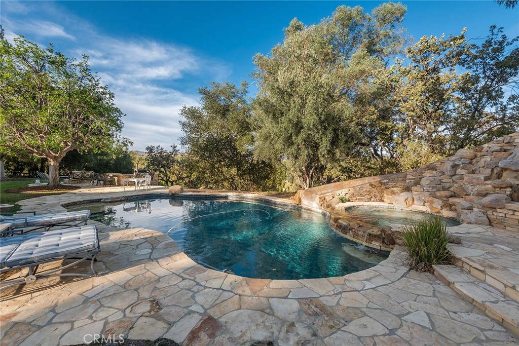 5747 Hoback Glen Road Hidden Hills, CA 91302 - Photo 33 of 37 a view of a swimming pool with outdoor seating
