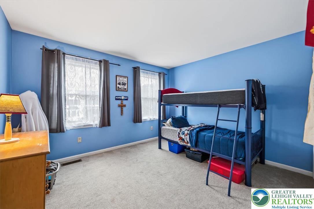 2011 Fieldview Drive Nazareth, PA 18064 - Photo 26 of 52 A cheerful room with plush carpeting and natural light from twin windows, offering a versatile space.
