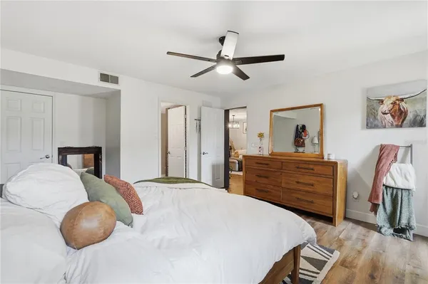 a bedroom with a bed and wooden floor