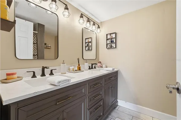 a bathroom with a double vanity sink and a mirror