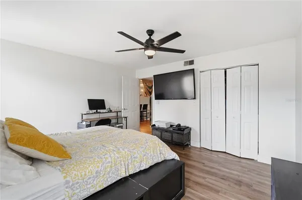 a bedroom with a bed and a flat screen tv