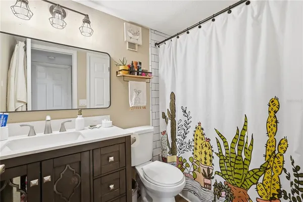 a bathroom with a toilet a sink and a mirror