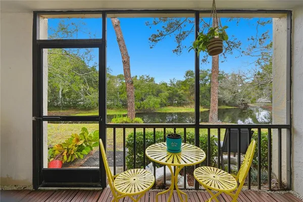 a view of a chairs and table in the balcony