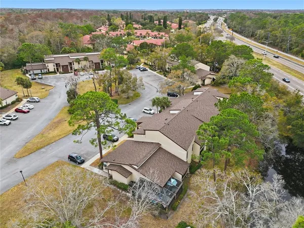 an aerial view of a house with a yard