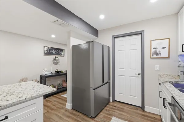 a kitchen with stainless steel appliances granite countertop a refrigerator and a stove top oven