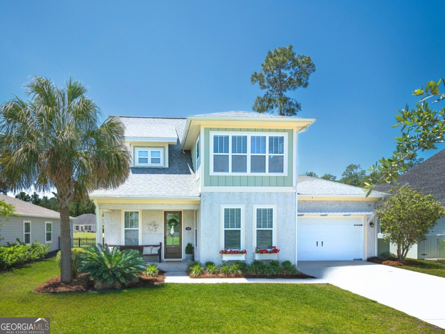 106 Boatsman Way St. Marys, GA 31558 - Photo 1 of 52 a front view of a house with a yard and palm trees
