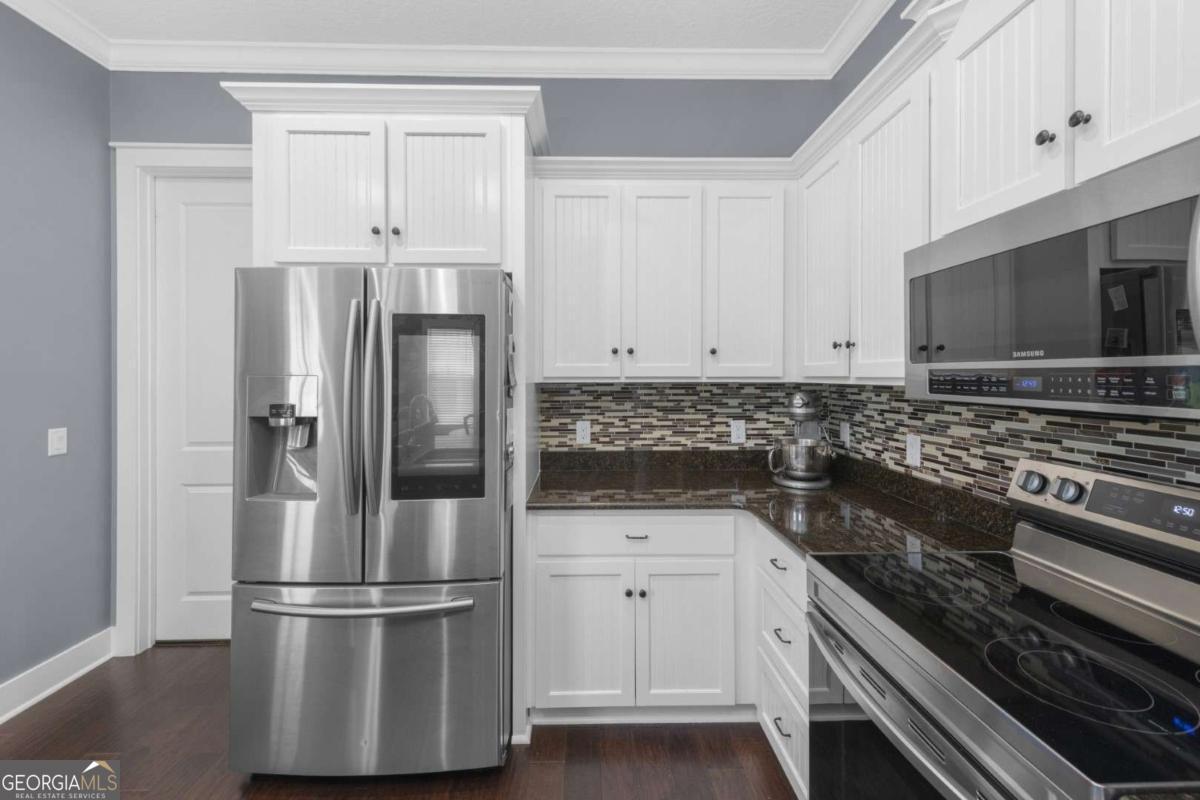 106 Boatsman Way St. Marys, GA 31558 - Photo 12 of 52 a kitchen with cabinets and stainless steel appliances