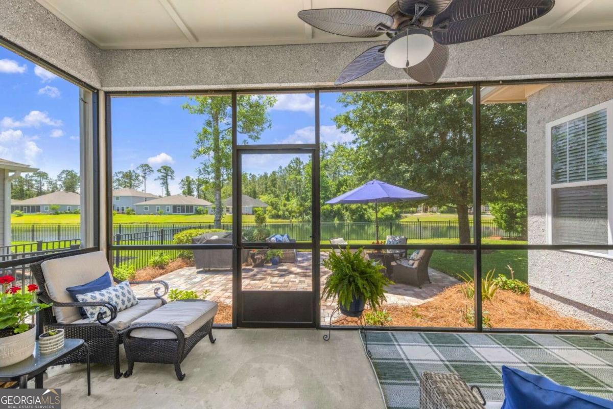 106 Boatsman Way St. Marys, GA 31558 - Photo 15 of 52 a room with furniture and a floor to ceiling window